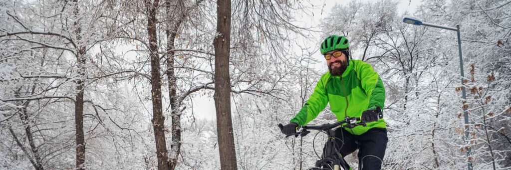 Man som cyklar i vinterväglag